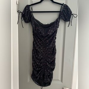 More To Come black dress. Roses. Cinched sides. Size XS. Detailed sleeves.